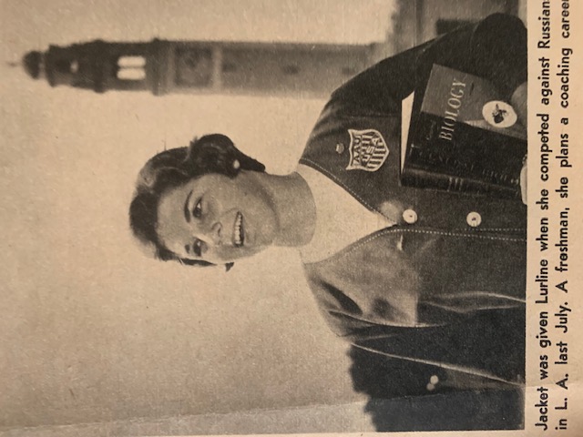 Lurline Hamilton on LSU campus as a freshman Lurline Hamilton smiles while holding a book and wearing an AAU jacket, standing on LSU’s campus with the Memorial Tower in the background.