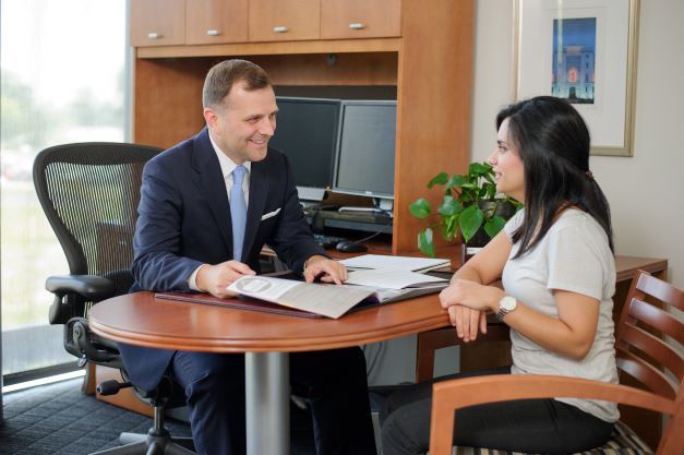 Couselor advises student in office.