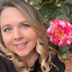 jen blanchard headshot with camellia bloom
